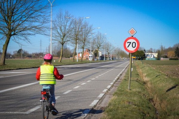 kind fietst langs gewestwegmet 70 km/u snelheidslimiet